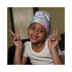 A young child wearing the Artis Styling Satin Headscarf