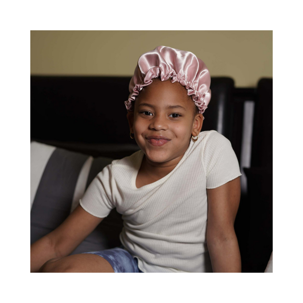 
            
                Load image into Gallery viewer, A child wearing the Artis Styling Satin Adjustable Bonnet
            
        